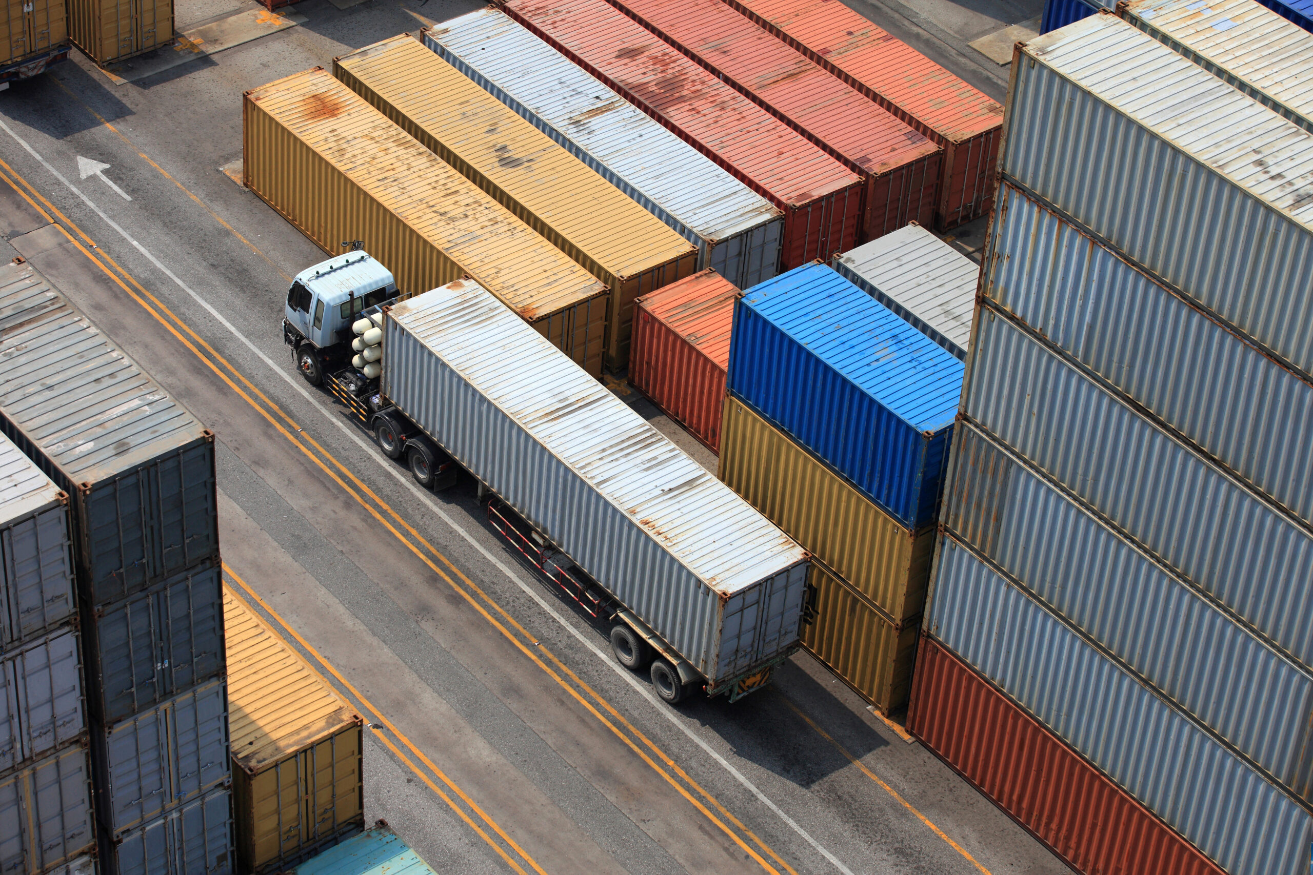 Container truck completing port pickup with chassis and gate turn coordination to protect delivery windows